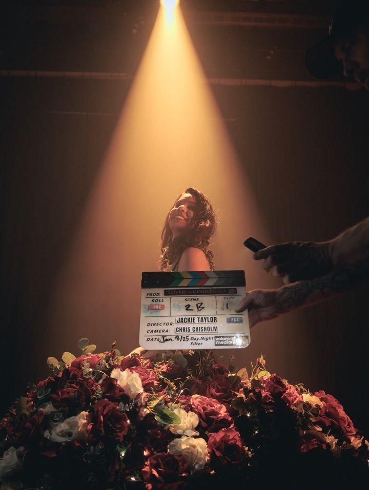 Clapperboard in front of a spotlit talent