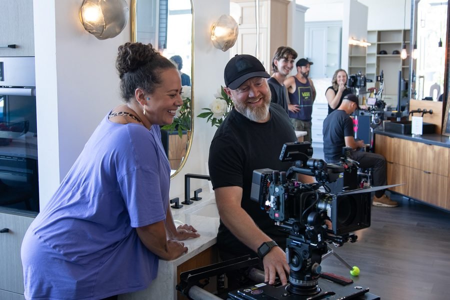 Camera operator with a client on a showroom shoot