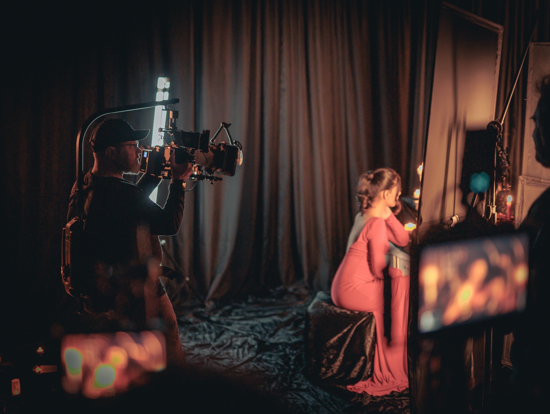 Volare Media camera operator filming talent on a styled set in BC — crew, monitors and lighting at work